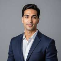 Professional LinkedIn headshot photograph, looking directly at camera, wearing navy blue business su